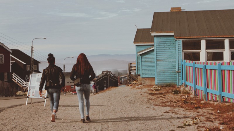 Two women stroll in Ilulissat, Greenland 