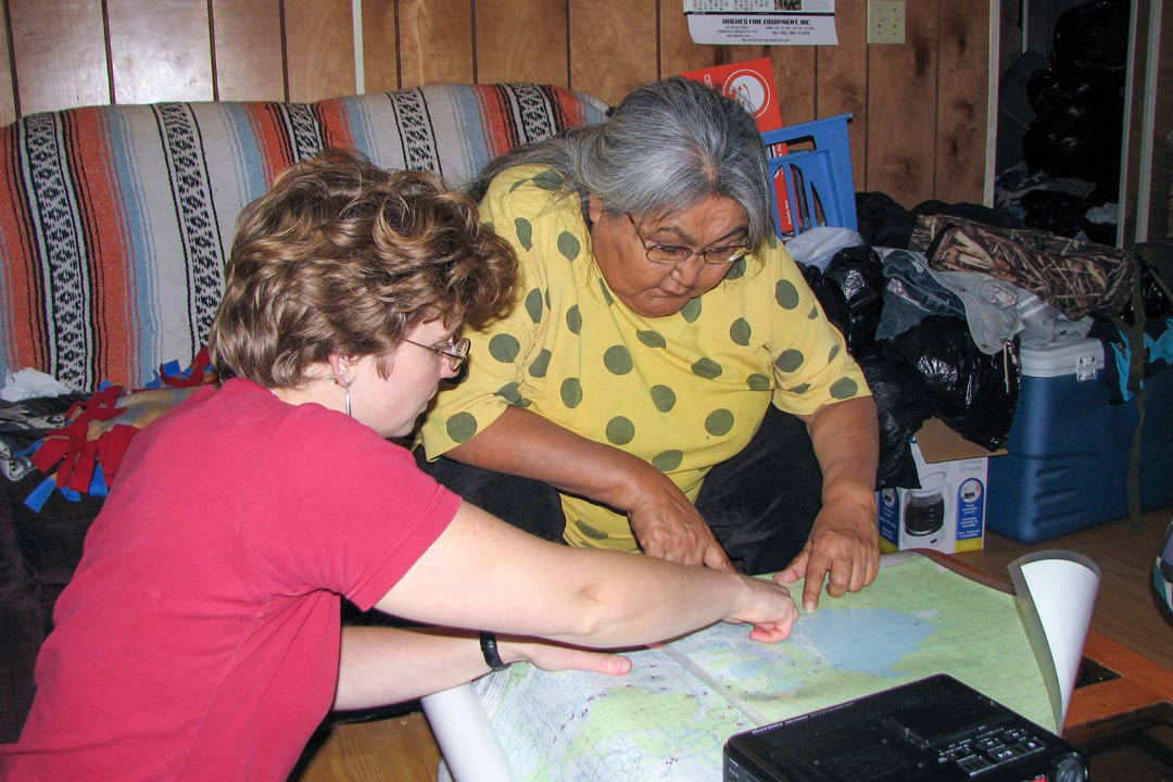 Dr. Olga Lovick (PhD) reviews Upper Tanana place names with the late Cora H. David, an Elder, storyteller and teacher, at David’s home in Tetlin, Alaska, in 2009